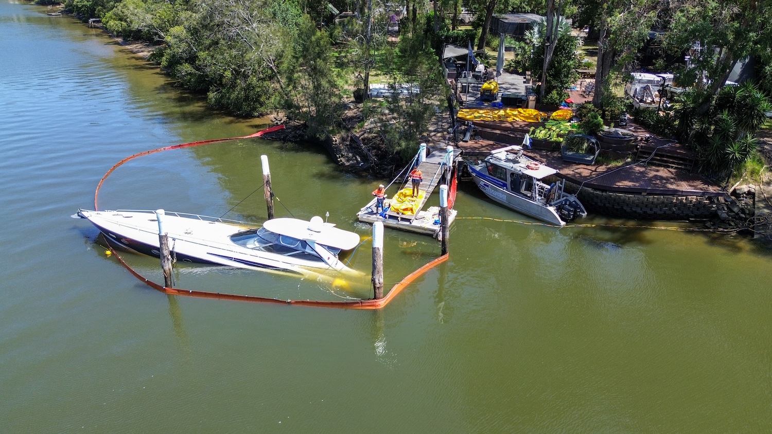 small motor boat submerged half way under water depicting marine salvage