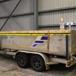 a small Franmarine work boat called Punt with a Honda engin stored in a large shipyard