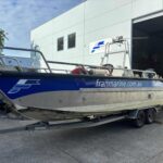 a small Franmarine work vessel called Seagull being pulled out of warehouse on trailer with wheels