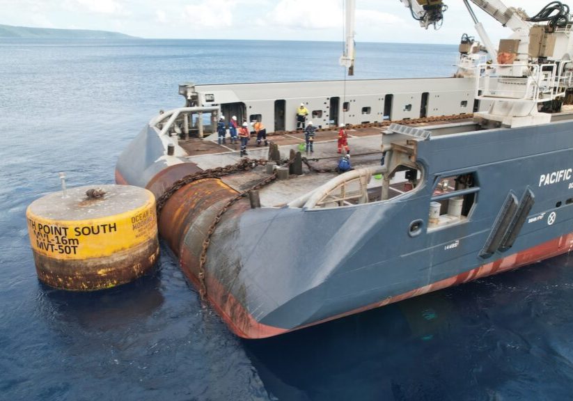 large shipping vessel Pacific Centurion anchored at sea with workers on board